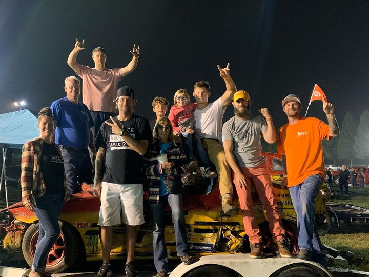 Dave's crew posing on the trailer with the #75 car at night